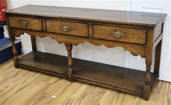 An oak three drawer sideboard